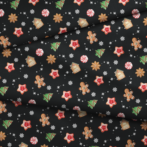 Patrón navideño con galletas decoradas en forma de estrellas, copos de nieve, árbol, casa y muñeco de jengibre sobre fondo negro. fabric fold mockup