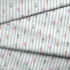 Patrón de rayas verticales gris con pequeños motivos florales en rosado, naranja y verde agua dispersos fabric fold mockup