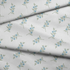 Patrón floral azul con ramas delicadas sobre fondo de rayas blancas y grises, estilo botánico fabric fold mockup