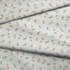 Patrón delicado de flores pequeñas en tonos rosado, amarillo y azul sobre fondo gris con rayas blancas fabric fold mockup