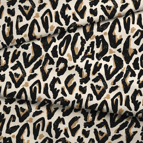 Estampado abstracto negro y dorado con formas orgánicas irregulares sobre fondo crema fabric fold mockup
