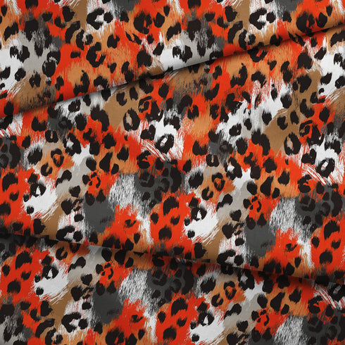 Estampado abstracto con manchas de leopardo en naranja, negro, blanco y café fabric fold mockup