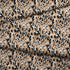 Estampado animal print en negro, café y blanco con manchas difuminadas estilo leopardo fabric fold mockup