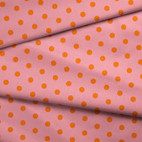 Patrón de pepas naranjas sobre fondo rosado