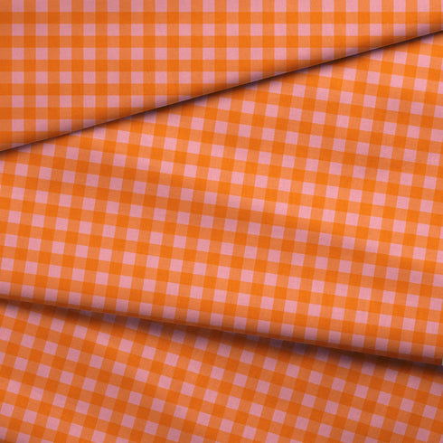 Patrón de cuadros en tonos naranja, rosado y coral vibrantes formando diseño de cuadrícula uniforme