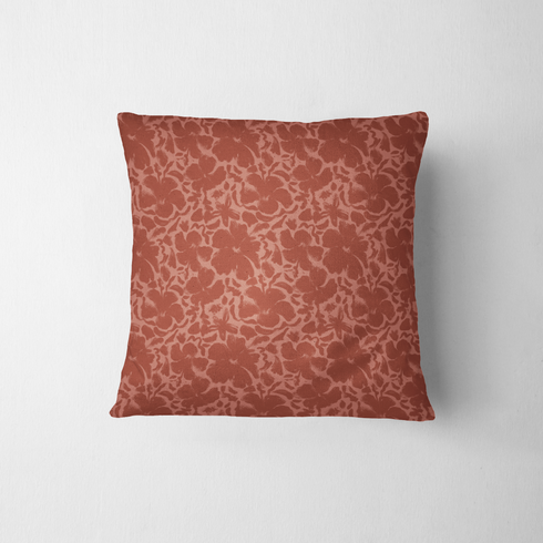 Red-brown floral pattern with abstract flowers on a lighter coral background fabric pillow mockup
