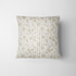 Patrón delicado de ramas verdes sobre rayas verticales beige y crema con estilo botánico suave fabric pillow mockup