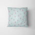 Patrón de rayas verticales turquesa sobre fondo blanco con motivos de hojas rosado coral dispersos fabric pillow mockup