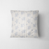 Patrón de rayas verticales con motivos florales delicados en tonos azules sobre fondo crema fabric pillow mockup