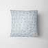 Patrón floral con líneas verticales en tonos azules, flores rosadas y amarillas sobre fondo rayado fabric pillow mockup
