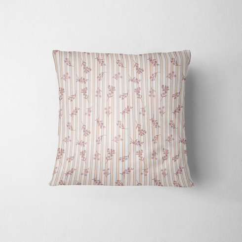 Patrón de rayas verticales en tonos rosado pálido y crema con delicados motivos florales de ramas y hojas fabric pillow mockup