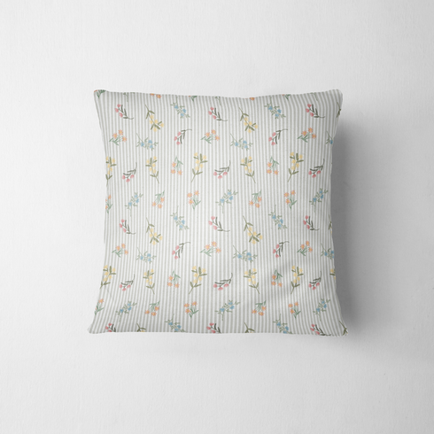 Patrón delicado de flores pequeñas en tonos rosado, amarillo y azul sobre fondo gris con rayas blancas fabric pillow mockup