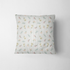Patrón delicado de flores pequeñas en tonos rosado, amarillo y azul sobre fondo gris con rayas blancas fabric pillow mockup