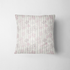 Patrón floral con flores rosado pálido sobre fondo de rayas verticales en tonos crema y beige fabric pillow mockup