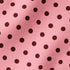 Patrón de pepas café sobre fondo rosado