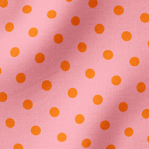 Patrón de pepas naranjas sobre fondo rosado