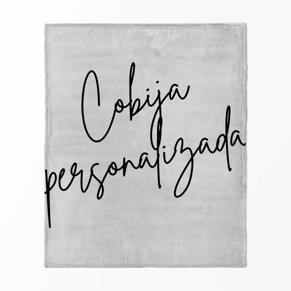 Firma cursiva en tinta negra sobre fondo gris claro.