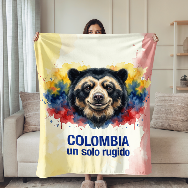 Cara de oso andino sobre fondo con salpicaduras amarillo azul rojo, texto "COLOMBIA un solo rugido sutex blanket person new