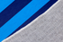 Palabra "HOLA" en naranja sobre fondo de rayas verticales azules y azul marino sutex rug 2x3 closeup texture angled