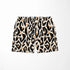 Estampado abstracto negro y dorado con formas orgánicas irregulares sobre fondo crema sutex swimtrunks