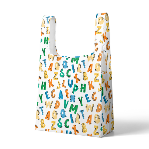 Patrón colorido de letras del alfabeto con diseños estilo dinosaurio en tonos azul, verde, amarillo y naranja sobre fondo blanco. sutex tote mockup