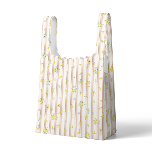 Patrón delicado con flores amarillas pequeñas sobre fondo de rayas rosado y crema suave sutex tote mockup