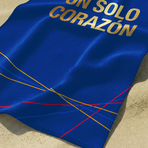 Fondo azul marino con líneas geométricas doradas y rojas, texto "UN SOLO CORAZÓN" en amarillo sutex towel closeup