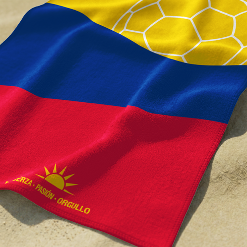Bandera colombiana estilizada con balón de fútbol amarillo bajo sol radiante sobre franjas azul y roja sutex towel closeup