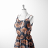 Flores estilizadas en tonos ocre y marrón sobre fondo negro oscuro, diseño artístico botánico decorativo sutex woven dress form mockup