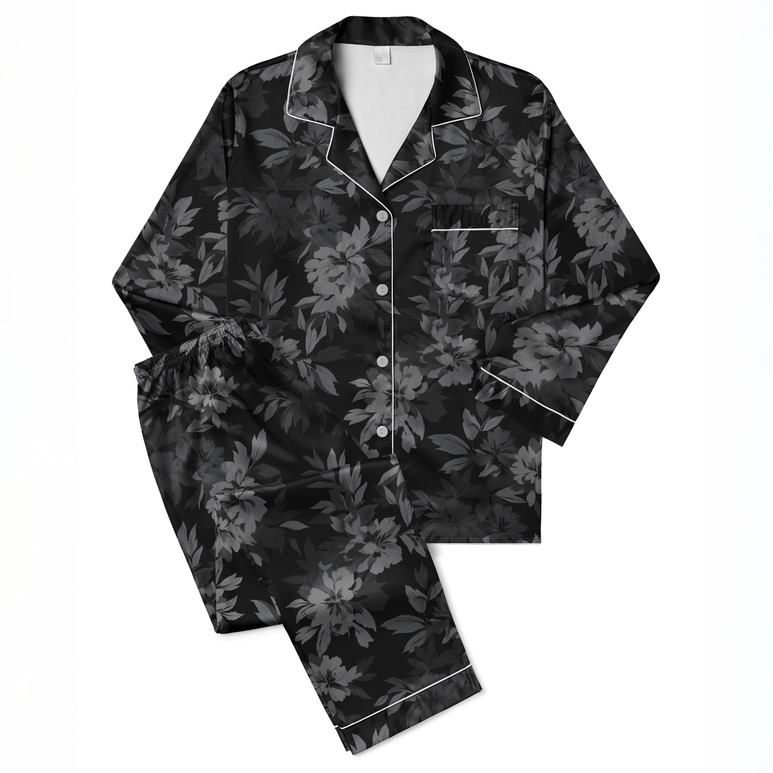 Patrón oscuro de hojas tropicales sobre fondo negro, en tonos grises y negros, creando un efecto monocromático elegante. sutex pajamas fullview mockup